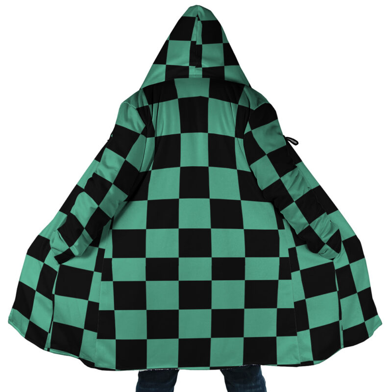 A person wearing the Tanjiro Kamado Demon Slayer Dream Cloak Coat, featuring a green and black checkered pattern inspired by the anime Demon Slayer, spreads it open to reveal the full design.