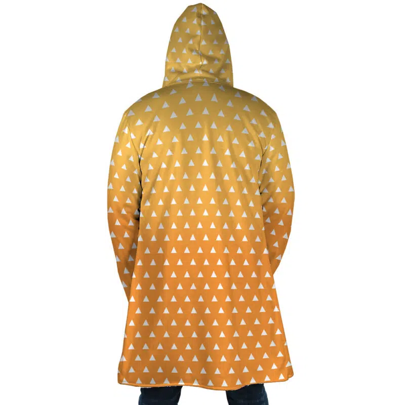 A person seen from behind wears the Zenitsu Agatsuma Demon Slayer Dream Cloak Coat, featuring a yellow hood, small white triangles, and a gradient from bright yellow to orange. The cloak falls below the knees.