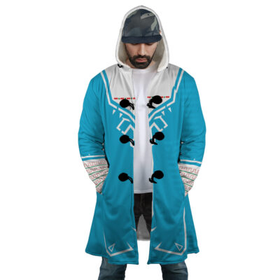 A man stands with hands in pockets, looking down, wearing the Breath of Wild Zelda Dream Cloak Coat—a blue and white hooded coat with geometric patterns—plus a camouflage cap under the hood.