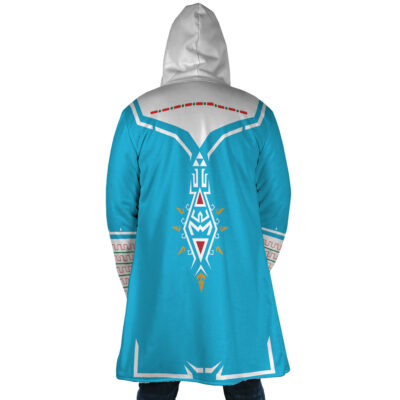 A person seen from behind wears the Breath of Wild Zelda Dream Cloak Coat, featuring light blue fabric with white and red geometric patterns and symbols on the back and sleeves, inspired by fantasy video game design.