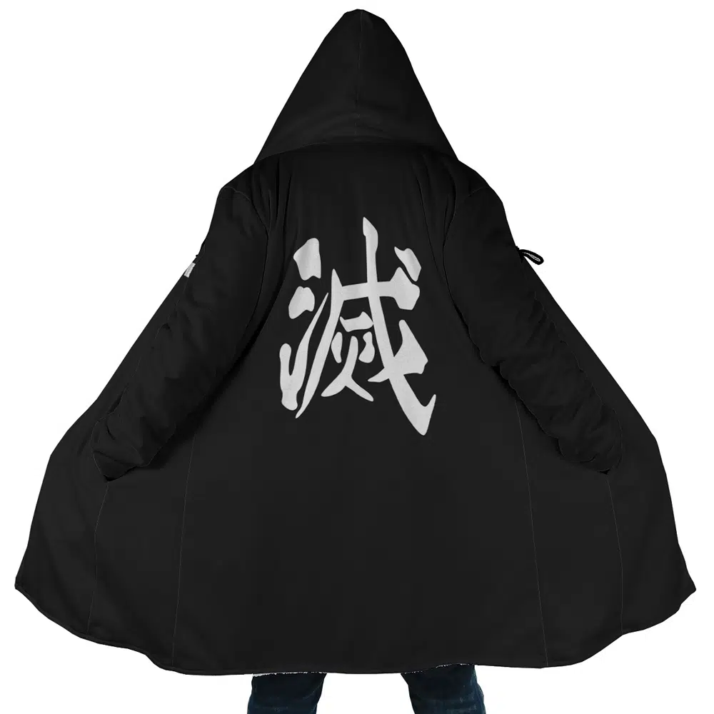 A person wearing the Demon Slayer Corps. Demon Slayer Dream Cloak Coat, a long black hooded coat with wide sleeves and large white Japanese kanji characters printed on the back, stands with their arms outstretched.