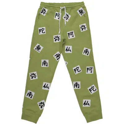 Light green Gyomei Himejima Demon Slayer sweatpants with white drawstrings, decorated with black and white patches featuring East Asian characters printed throughout the fabric.