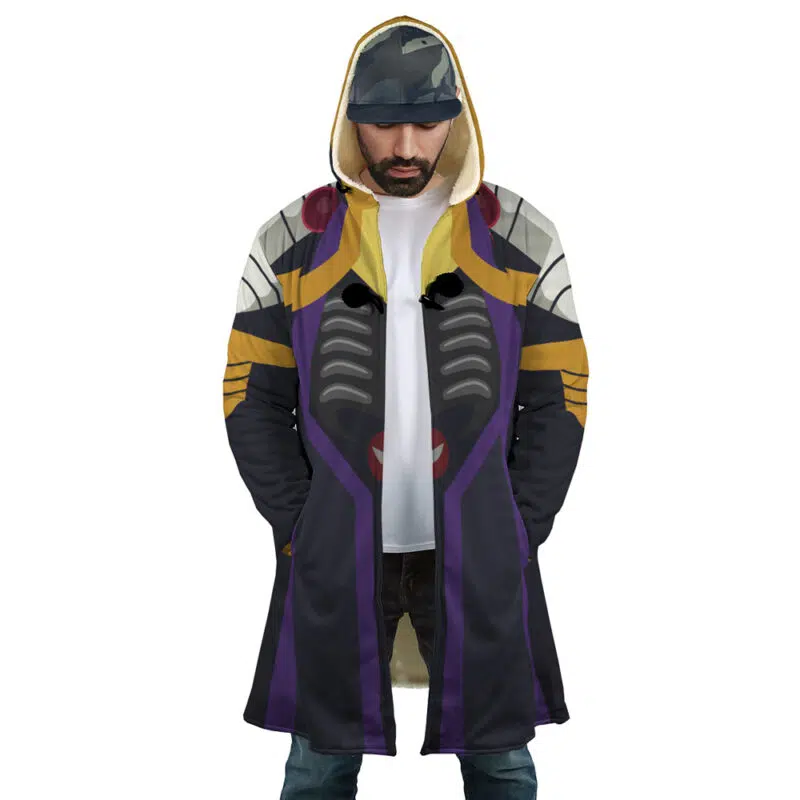 A man wears the Momonga Overlord Dream Cloak Coat, a long hooded coat with bold black, purple, gold, and gray patterns inspired by futuristic armor, standing hands-in-pockets.
