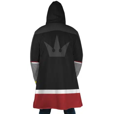 Someone seen from behind wearing the Sora Kingdom Hearts Dream Cloak Coat—a hooded black coat with gray shoulders, red and white stripes at the bottom, and a gray crown emblem on the back.