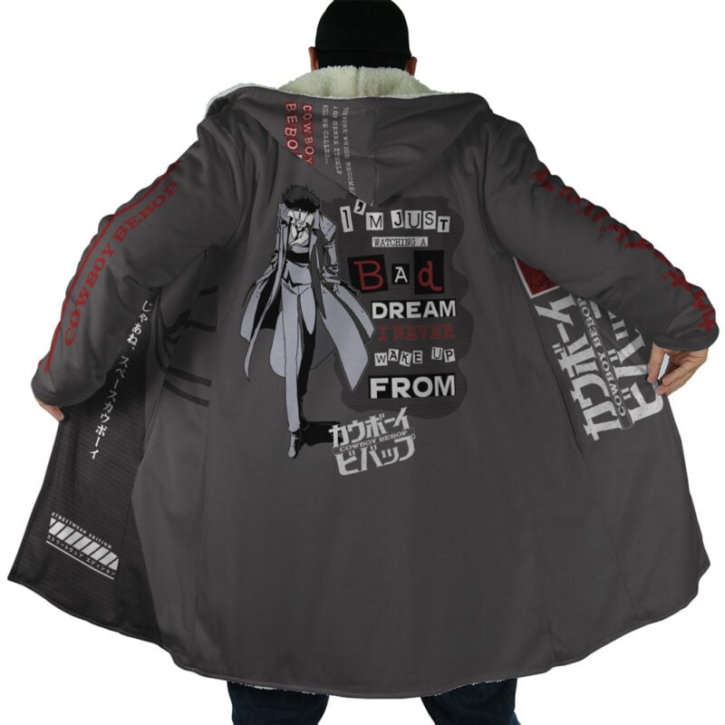 A person wearing the Spiegel Spike 2 Dream Cowboy Bebop Dream Cloak Coat, featuring dark fabric, anime art of Spike Spiegel, Japanese text, and the phrase "I'm just a bad dream I never wake up from.