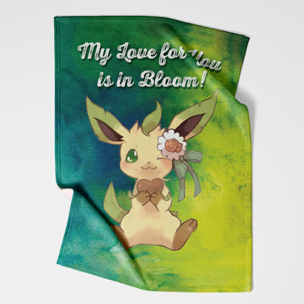The Leafeon Bloom Pokemon Hooded Blanket features a cute cartoon Leafeon holding a heart, winking, and wearing a flower, set against a green and blue background with "My Love for You is in Bloom!" at the top.