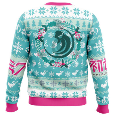 The Christmas Symphony Hatsune Miku Ugly Christmas Sweater features teal, white, and pink colors with snowflakes, music notes, swans, pine trees, holly, pink cuffs and hem, and a central circle showing teal-haired Hatsune Miku.