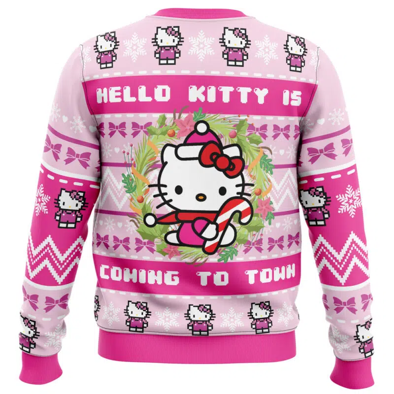 The Hello Kitty is Coming to Town Ugly Christmas Sweater features Hello Kitty in a Santa hat with a candy cane, surrounded by wreaths, snowflakes, bows, and festive text.