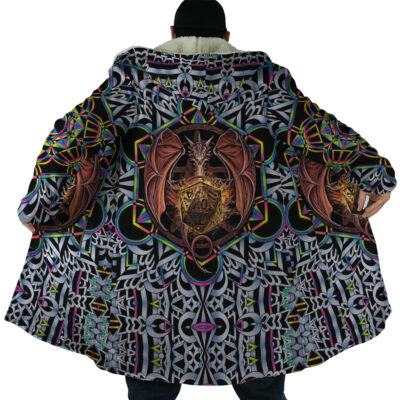 Someone wears the Trippy Dungeons & Dragons Dream Cloak Coat, featuring a bold dragon-with-shield design on the back and intricate geometric patterns in black, white, green, purple, and gold.