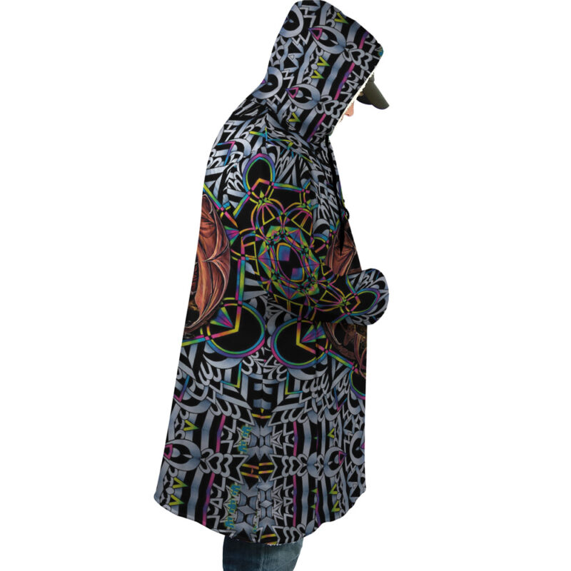 A person in profile models the Trippy Dungeons & Dragons Dream Cloak Coat, a long hooded piece with a vibrant geometric and abstract pattern in black, white, green, yellow, pink, and orange.