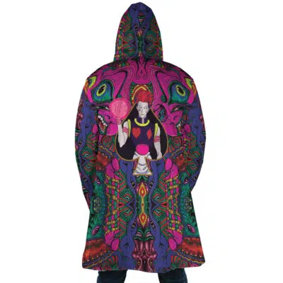 A person wears the Trippy Mystic Faces Hisoka Hunter X Hunter Dream Cloak Coat, featuring a colorful psychedelic pattern with a red-haired figure holding a pink orb amidst vibrant abstract designs.