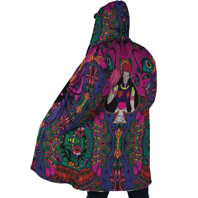 Someone wears the Trippy Mystic Faces Hisoka Hunter X Hunter Dream Cloak Coat, a colorful hooded jacket with psychedelic patterns, abstract green, purple, pink, and orange designs, and an illustrated Hisoka character with red hair and gloves on the back.