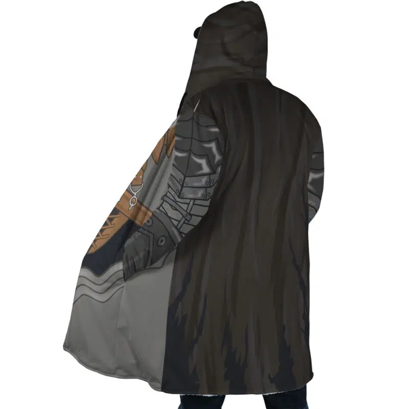 A person is seen from the back wearing the Guts Armor Berserk Dream Cloak Coat—a long, hooded coat with an armor print and a dark, fur-like cape. The hood is up, partly obscuring their head and face.