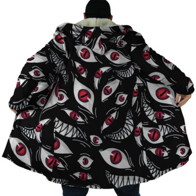 Wearing the Pride Fullmetal Alchemist Dream Cloak Coat, someone stands with arms outstretched, showing off bold red eye and white jagged teeth designs on the back.
