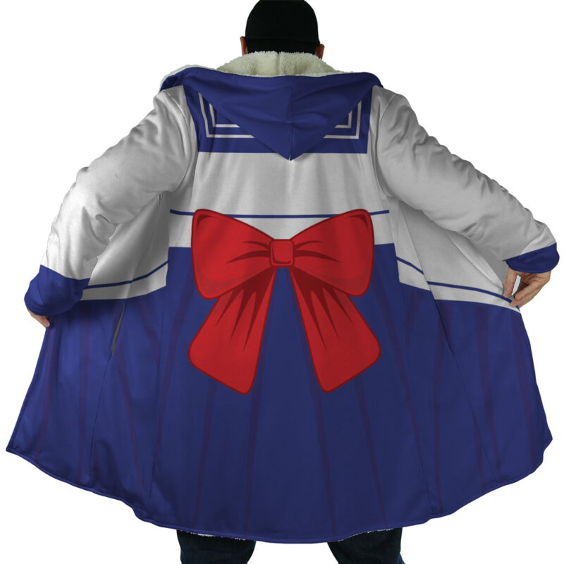 Someone wearing the Sailor Guardian Sailor Moon Dream Cloak Coat, featuring a long hooded design styled like a sailor school uniform with a large red bow on the back, blue skirt details, and white-and-blue trim, arms extended to show off the coat.
