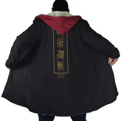 A person wears the Yuji Itadori Jujutsu Kaisen Dream Cloak Coat, a long black coat with a red hood, holding it open. The back features gold Japanese characters and JUJUTSU KAISEN printed below.
