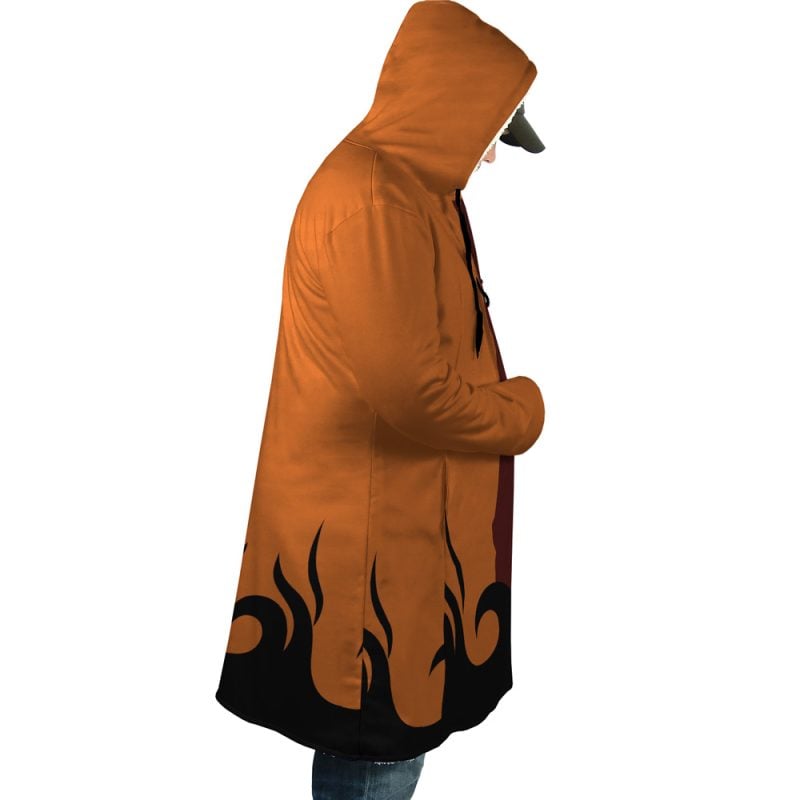 Someone wearing the Hokage Orange Shippuden Dream Cloak Coat, featuring a long orange design with black flame patterns near the hem and a hood, stands in profile against a white background.