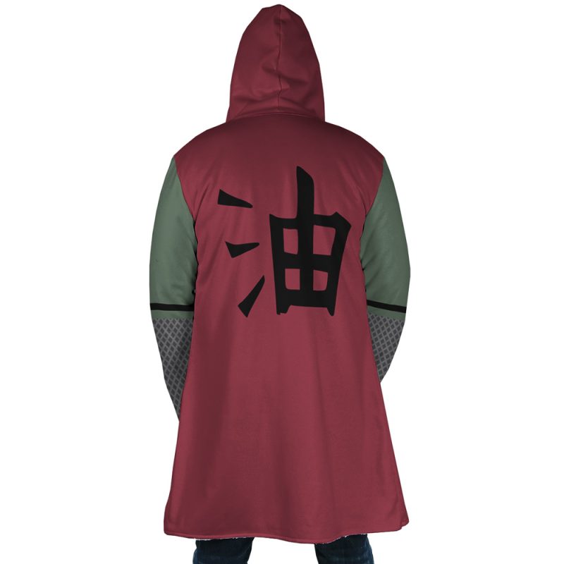 A person wearing the Jiraiya Uniform Shippuden Dream Cloak Coat, featuring a red hood, green sleeves, and a large black kanji on the back, stands with their back to the camera.