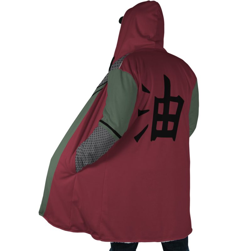 A person seen from behind wears the Jiraiya Uniform Shippuden Dream Cloak Coat, featuring a maroon hood, green sleeves, and a large black Japanese kanji character printed on the back.