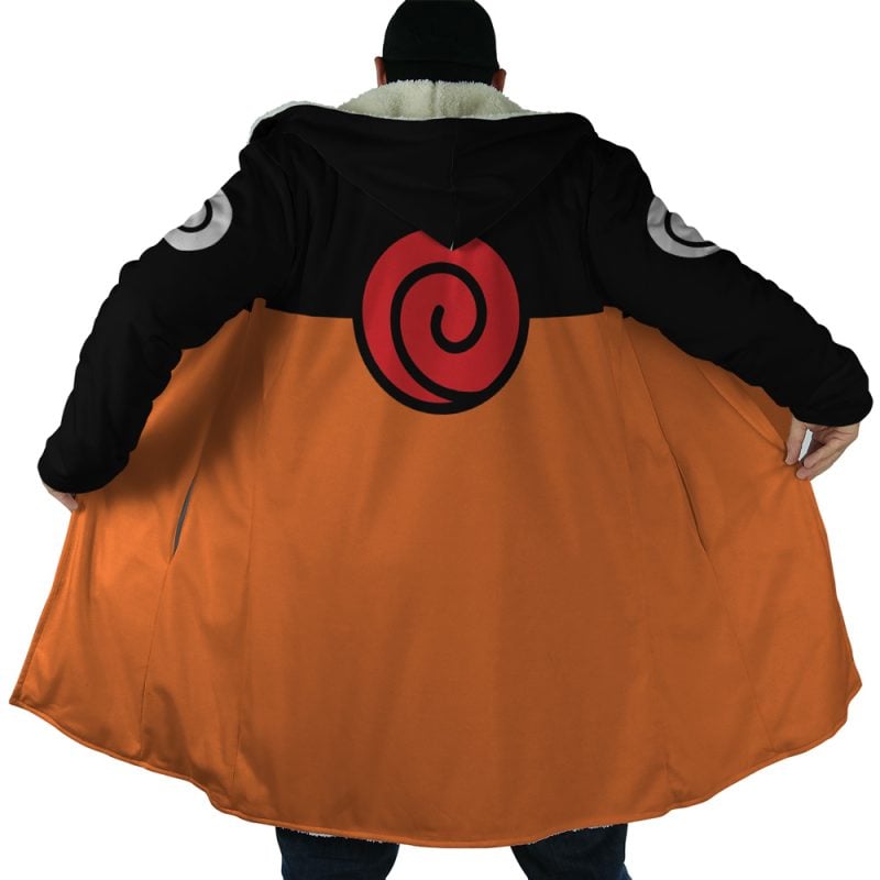 A person wearing the Uzumaki Shippuden Dream Cloak Coat faces away, showing off its black top, orange bottom, large red swirl on the back, and open cloak revealing the contrasting inside lining.