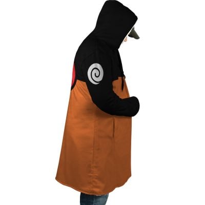 A person in a side view wears the Uzumaki Shippuden Dream Cloak Coat, a character-inspired hooded cloak with black top, orange bottom, and spiral symbols on the arm and back.