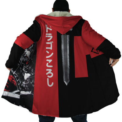 A person wearing the Guts Dragonslayer Berserk Dream Cloak Coat—a long red and black hooded coat with white fur trim, a sword graphic and Japanese text on the back, plus anime-style artwork printed on the inner lining.