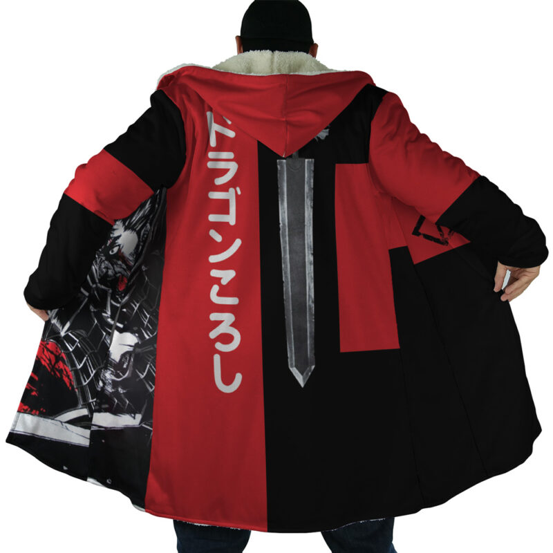 A person wearing the Guts Dragonslayer Berserk Dream Cloak Coat—a long red and black hooded coat with white fur trim, a sword graphic and Japanese text on the back, plus anime-style artwork printed on the inner lining.