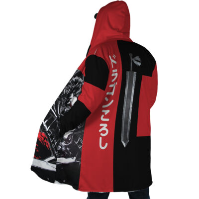 A person wears the Guts Dragonslayer Berserk Dream Cloak Coat, a red and black hooded coat featuring bold color blocks, dynamic anime-style artwork, Japanese text, and a large sword graphic on the back.