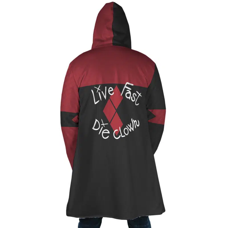 A person wears the Harley Quinn The Suicide Squad DC Dream Cloak Coat in black and dark red, featuring diamond shapes and "Live Fast Die Clown" in bold white lettering on the back.