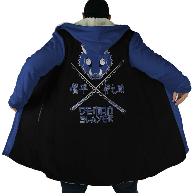Person wearing the Hashibira Inosuke Demon Slayer Dream Cloak Coat, blue and black with a hood, shows a stylized boar’s head over crossed swords and Japanese text on the back, plus “SLAYER” in English.