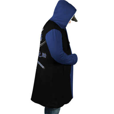 A person in profile wears the Hashibira Inosuke Demon Slayer Dream Cloak Coat, featuring a blue and black hood, graphic design, and text on the back. Theyre also in blue jeans and a black cap against a white background.