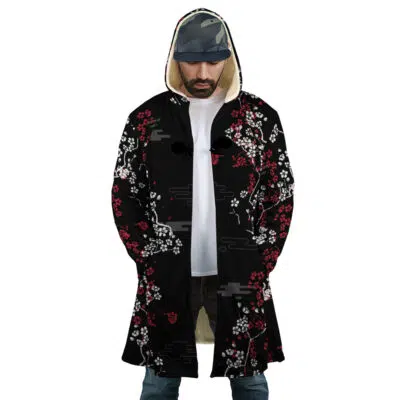 Wearing the Inarizaki Foxes Haikyuu Dream Cloak Coat, a white shirt, blue jeans, and a camouflage cap, a person stands with hands in pockets and looks down.