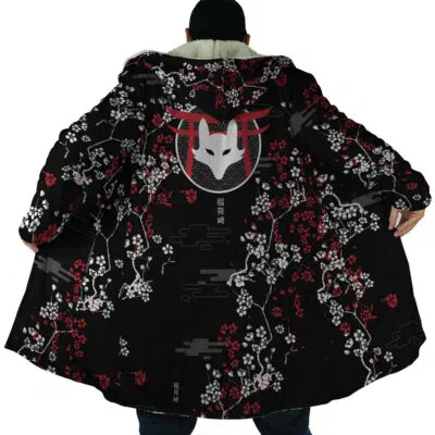 A person wearing the Inarizaki Foxes Haikyuu Dream Cloak Coat opens it to reveal a large fox mask design on the back, accented with Japanese-style art and cloud motifs. The black coat features striking red and white floral patterns. The wearer’s face is hidden.