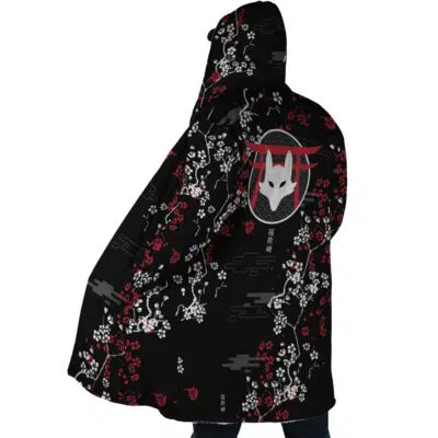 Someone wears the Inarizaki Foxes Haikyuu Dream Cloak Coat, a black hooded cloak with red and white cherry blossom patterns and a stylized white fox mask design on the back, covering most of their body as they face away from the camera.