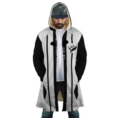 A man wears the Gotei 13 8th Division Captain Kyoraku Shunsui Bleach Dream Cloak Coat, featuring a hood, white front, black sleeves, and black vertical stripes. His hood is up and hands are in his pockets; Asian characters appear on his shirt.