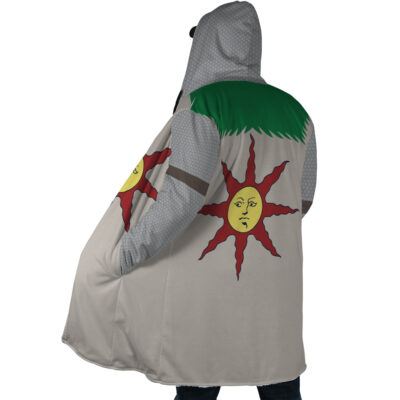 A person stands with their back to the camera, wearing the Praise the Sun Dark Souls Dream Cloak Coat, which features a large red sun with a face on a white background inspired by Solaire of Astora.