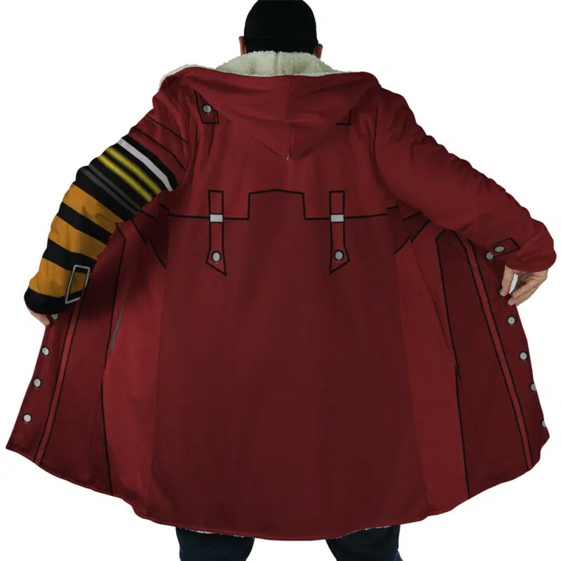 A person faces away, holding open the Vash the Stampede Trigun Dream Cloak Coat. The long red coat features cartoon-like outlined patterns, a fluffy inner collar, and black and yellow striped details on one sleeve.