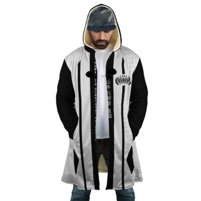 A man wears the 1st Division Captain Commander Yamamoto Genryusai Shigekuni Gotei 13 Bleach Dream Cloak Coat—white with black vertical stripes, fur-lined hood, Japanese text on the front—over a graphic t-shirt, hands in pockets, looking down.