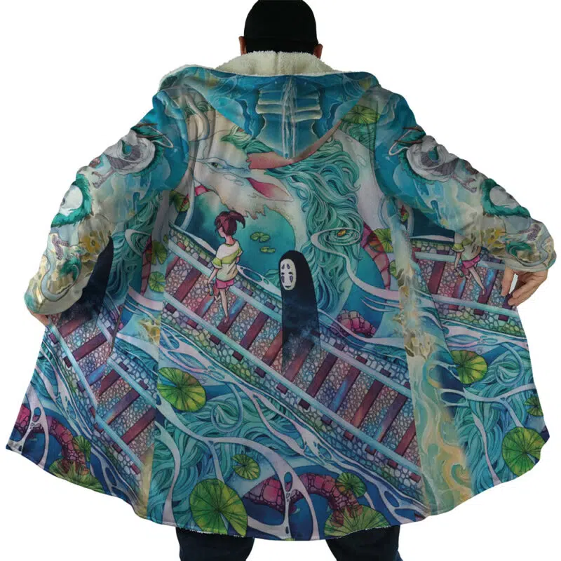 A person wears the Mythical Spirited Away Studio Ghibli Dream Cloak Coat, showcasing anime-inspired artwork with characters, water, and a bridge reminiscent of Spirited Away. Their arms are outstretched to display the design.