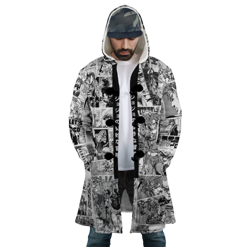 A man wears the Manga Panels Jojo's Bizarre Adventure Dream Cloak Coat, featuring black and white manga comic panels, paired with a white shirt, blue jeans, and a camouflage cap as he looks down with his hands in his pockets.