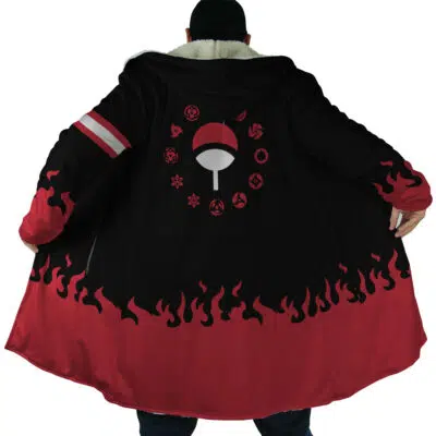 A person, back facing the camera, wears the Uchiha Clan Shippuden Dream Cloak Coat—a black and red cloak with a flame-patterned hem, Uchiha clan symbols, and other Naruto-inspired designs on the back.
