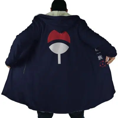 A person wears a long, dark blue Uchiha Clan Sharingan Shippuden Dream Cloak Coat with the Uchiha clan symbol from Naruto on the back. The open coat reveals a light lining and Japanese characters inside.
