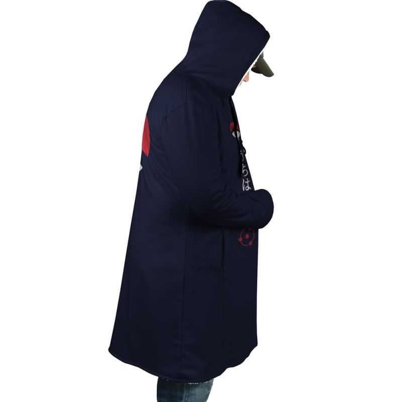 A person stands in profile with hands in pockets, wearing the Uchiha Clan Sharingan Shippuden Dream Cloak Coat and a cap, set against a white background.