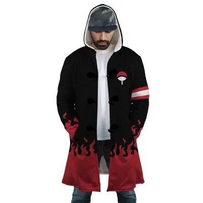 A man wears the Uchiha Clan Shippuden Dream Cloak Coat: black and red with flame designs at the hem and sleeves, a white clan symbol on the chest, striped armband, hood up, and a plain white shirt underneath.