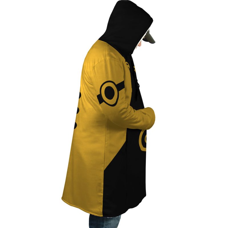 A person in profile wears the Six Paths Sage Mode Shippuden Dream Cloak Coat—yellow and black with circular sleeve designs—hood up, hands in pockets, and a black cap showing beneath the hood.