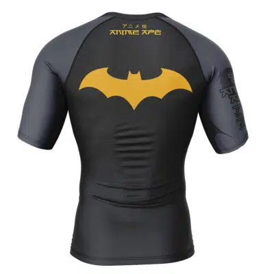 The Batman DC Comics Short Sleeve Rash Guard Compression Shirt in black and gray features a large yellow Batman logo on the back with Japanese text above it.