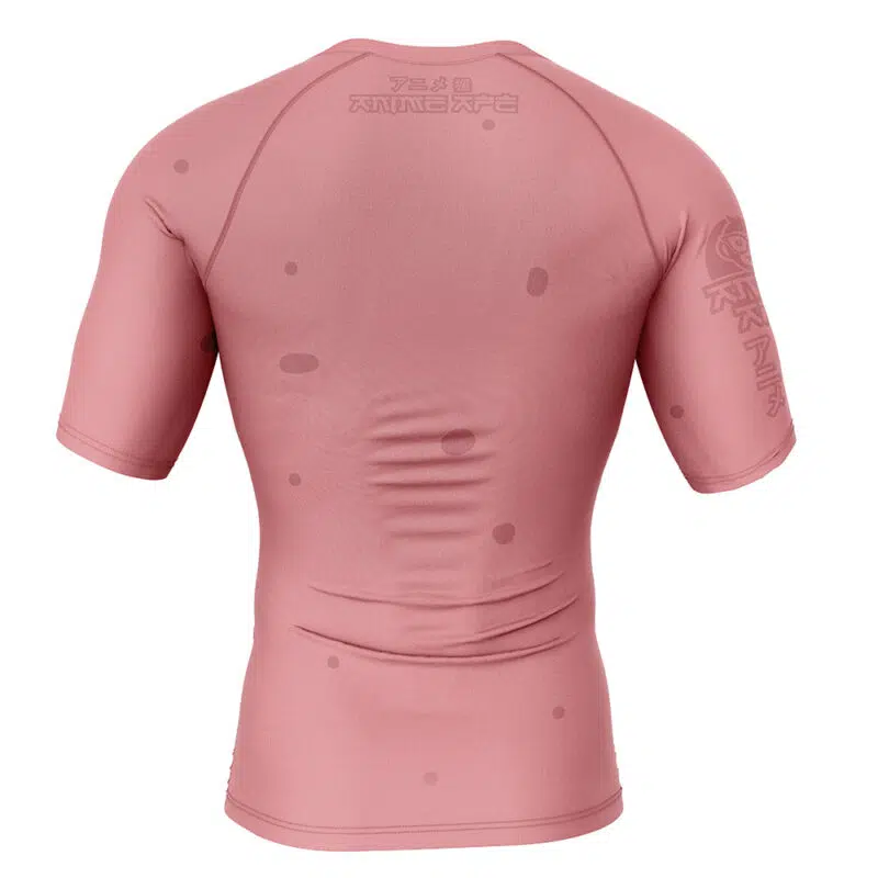 The Patrick Star SpongeBob SquarePants Short Sleeve Rash Guard Compression Shirt, shown from the back in muted pink, features faint text and symbols on the upper back and sleeve with small circular spots across the fabric.