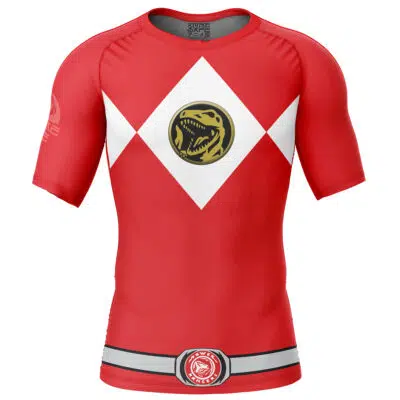 The Red Ranger Mighty Morphin Power Rangers Short Sleeve Rash Guard Compression Shirt features white diamond shapes on the chest, a gold dinosaur emblem, and a printed belt with a red logo, resembling the iconic Ranger uniform.