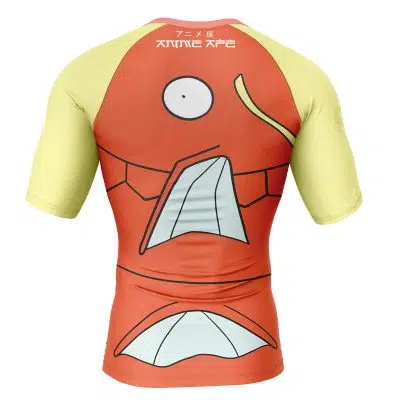 The Magikarp Face Pokémon Short Sleeve Rash Guard Compression Shirt features orange and yellow colors, large eyes, a gaping mouth, Japanese text near the collar, and a cartoon fish face design on the back.