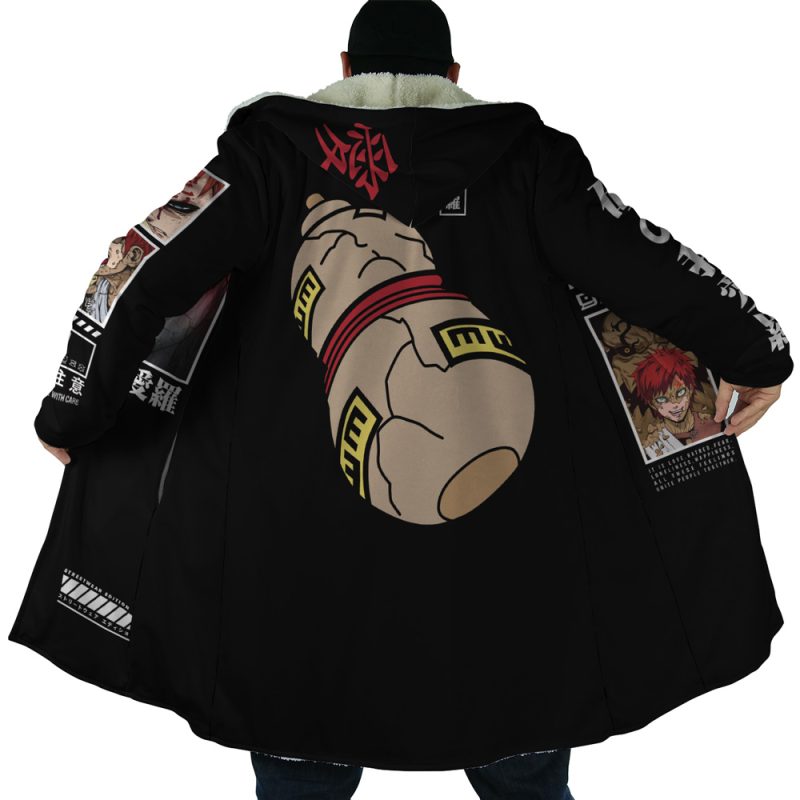 A person faces away, holding open the Gaara Shippuden Dream Cloak Coat, which features anime-style graphics such as a large robotic fist on the back and colorful manga panels lining the inside.